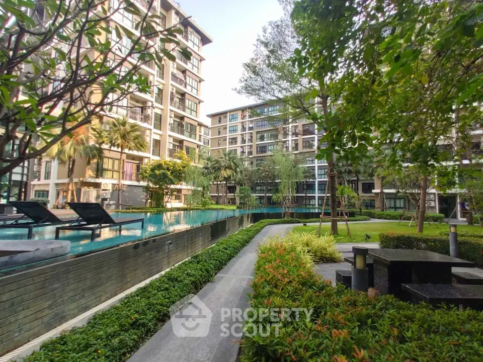 Luxurious residential complex with lush garden and inviting swimming pool