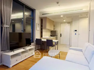 Modern living room with open kitchen and stylish furniture in a cozy apartment.