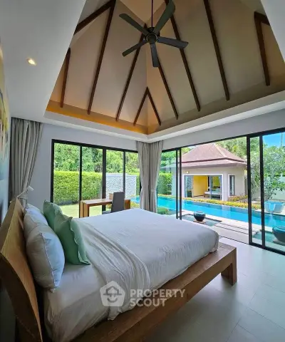 Luxurious bedroom with pool view and high ceiling in tropical villa