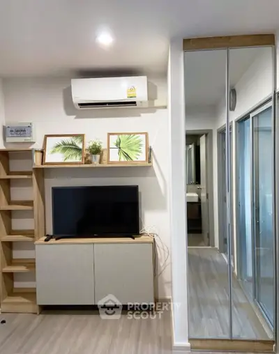 Modern living room with TV, air conditioning, and stylish decor