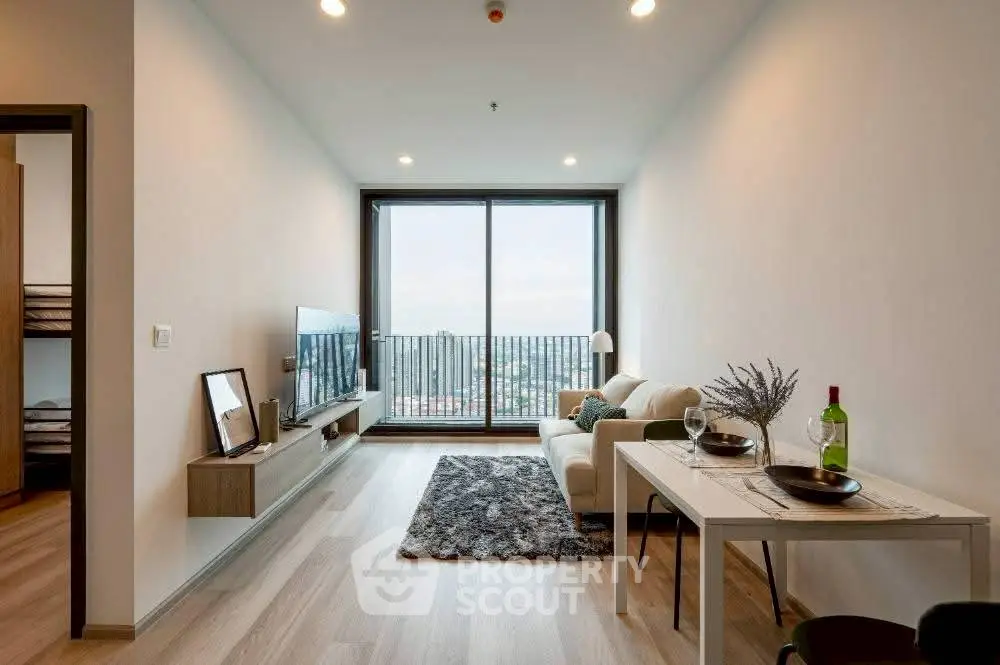 Modern living room with balcony view, sleek furniture, and stylish decor