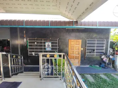 Charming exterior view of a modern home with stylish railing and lush greenery.