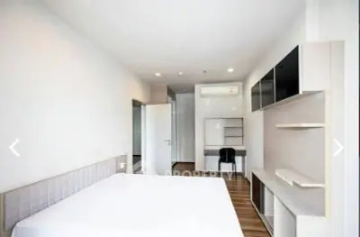 Spacious modern bedroom with sleek furniture and ample natural light