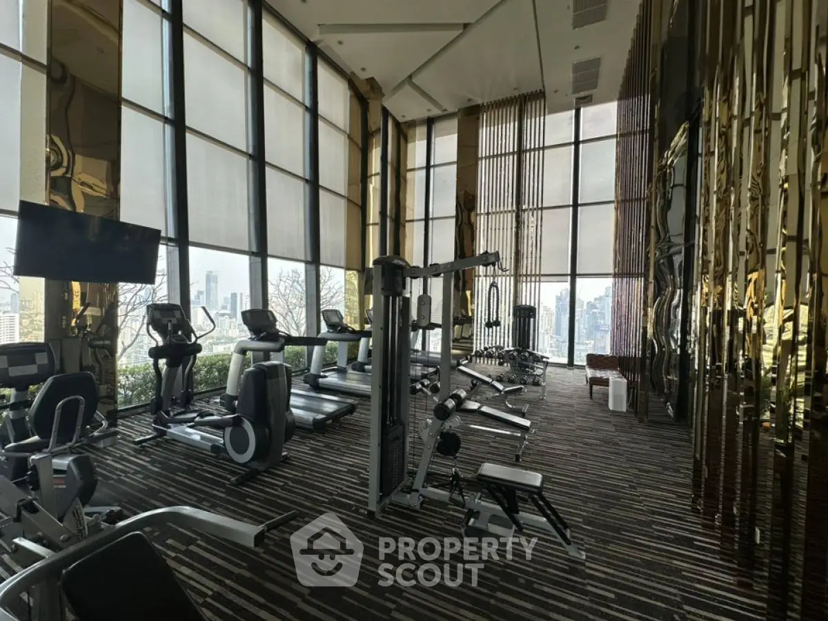 Luxurious high-rise gym with panoramic city views and modern fitness equipment.