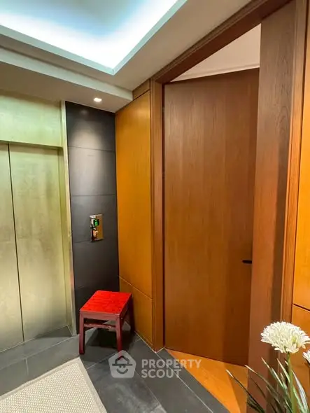 Luxurious elevator entrance with modern wood paneling and elegant decor