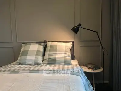 Cozy bedroom with stylish checkered bedding and modern floor lamp