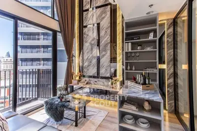 Luxurious modern living room with marble accents and city view balcony.