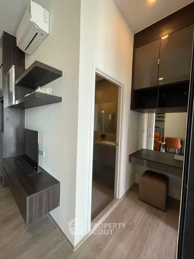 Modern apartment interior with sleek built-in furniture and air conditioning unit