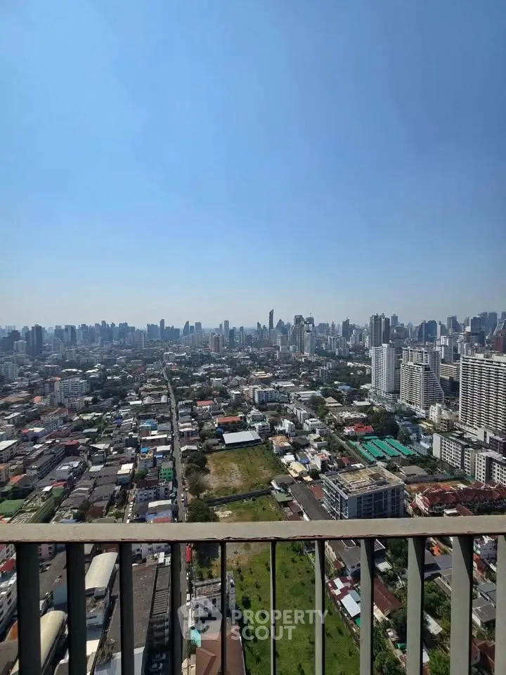 Stunning cityscape view from high-rise balcony showcasing urban skyline and vibrant city life.