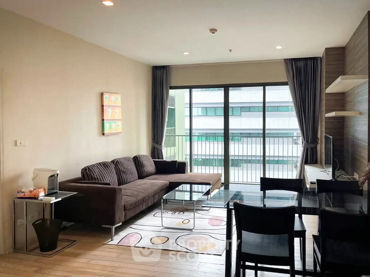 Modern living room with large windows and stylish furniture in a contemporary apartment.