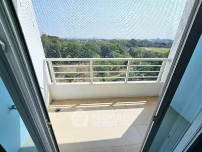 Spacious balcony with safety netting and scenic view of greenery