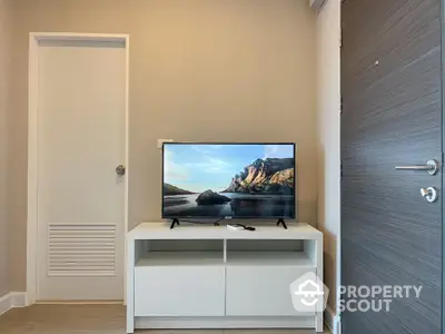 Modern living room with sleek TV stand and flat-screen TV, perfect for cozy entertainment.