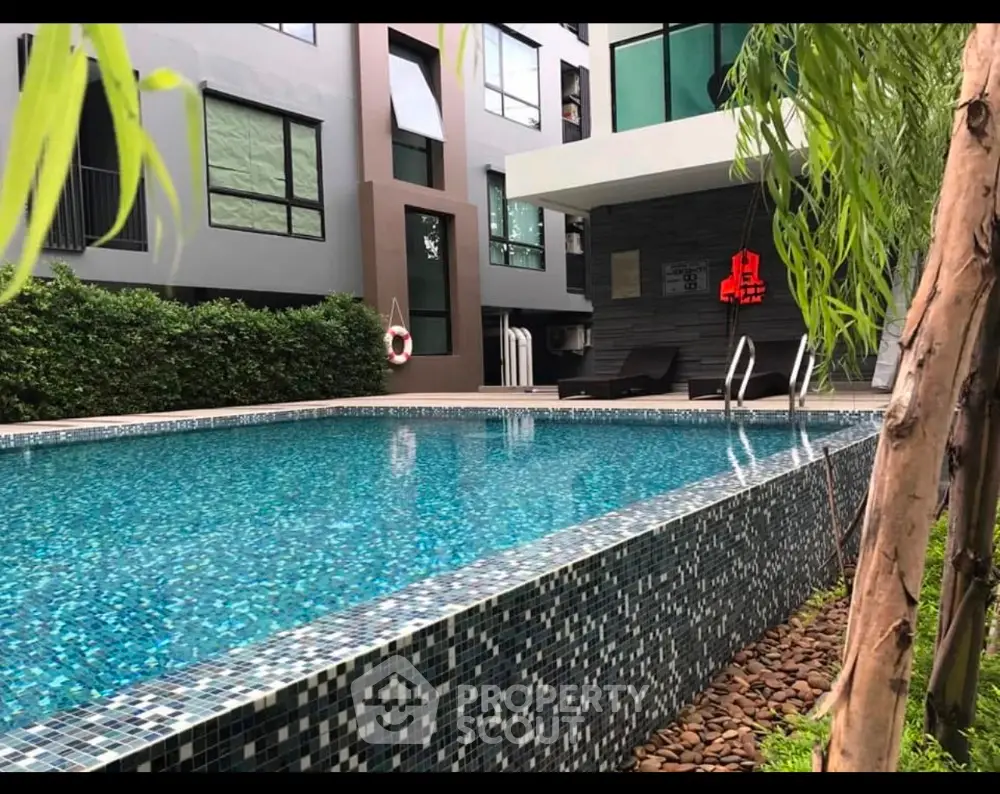 Luxurious modern apartment with stunning pool and lush greenery