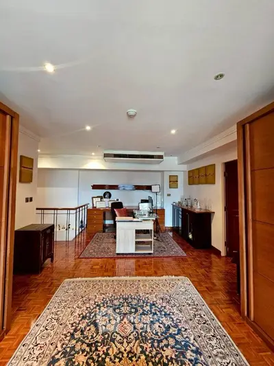 Spacious and elegant living room with luxurious decor and hardwood flooring.