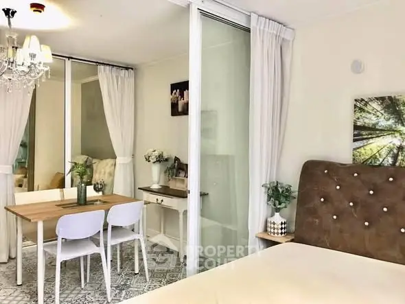 Charming bedroom with elegant decor and dining area, featuring a cozy ambiance and stylish furnishings.