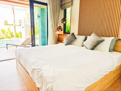 Luxurious bedroom with pool view and modern decor in a stylish home