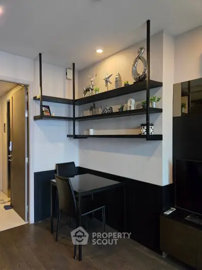 Modern living room with stylish shelving and dining area in a contemporary apartment.