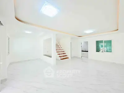 Spacious modern living room with elegant marble flooring and stylish ceiling lights