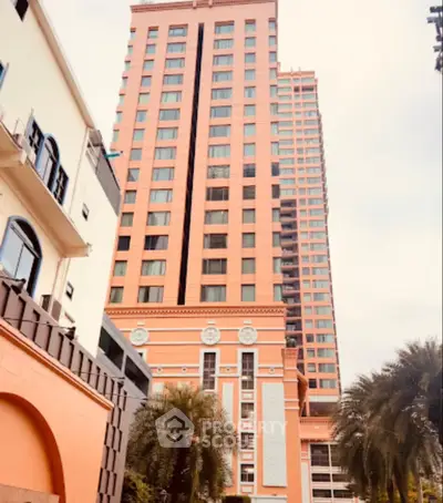 Stunning high-rise building with unique architectural design and lush greenery, perfect for urban living.