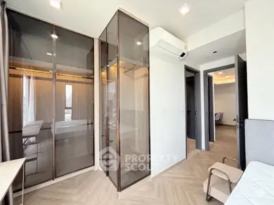 Modern bedroom with glass wardrobe and air conditioning in stylish apartment