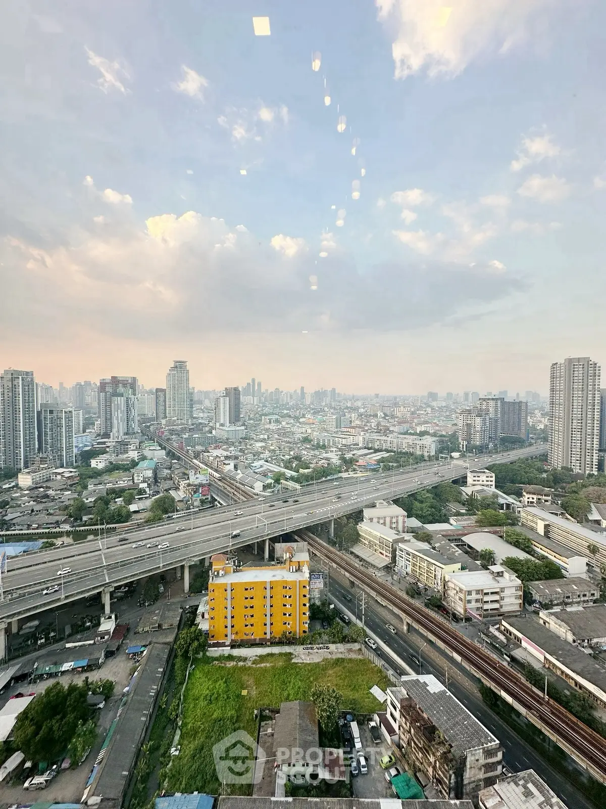 Stunning cityscape view from high-rise building with expansive skyline and urban infrastructure.