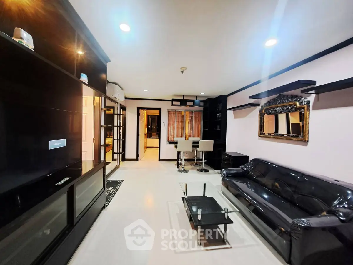 Modern living room with sleek black furniture and stylish decor