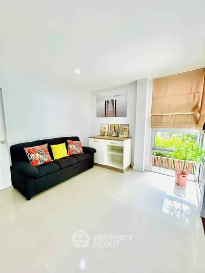 Bright living room with modern decor and large window view