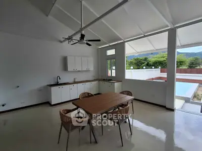 Spacious open-plan kitchen and dining area with modern design and scenic views.