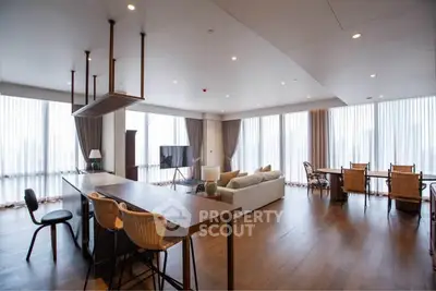 Spacious modern living room with open kitchen and panoramic windows