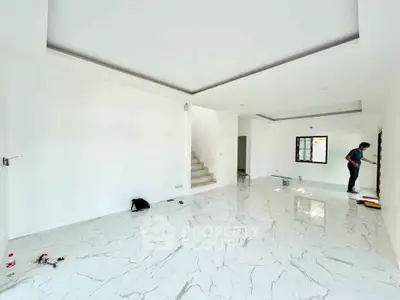 Spacious modern living room with marble flooring and staircase