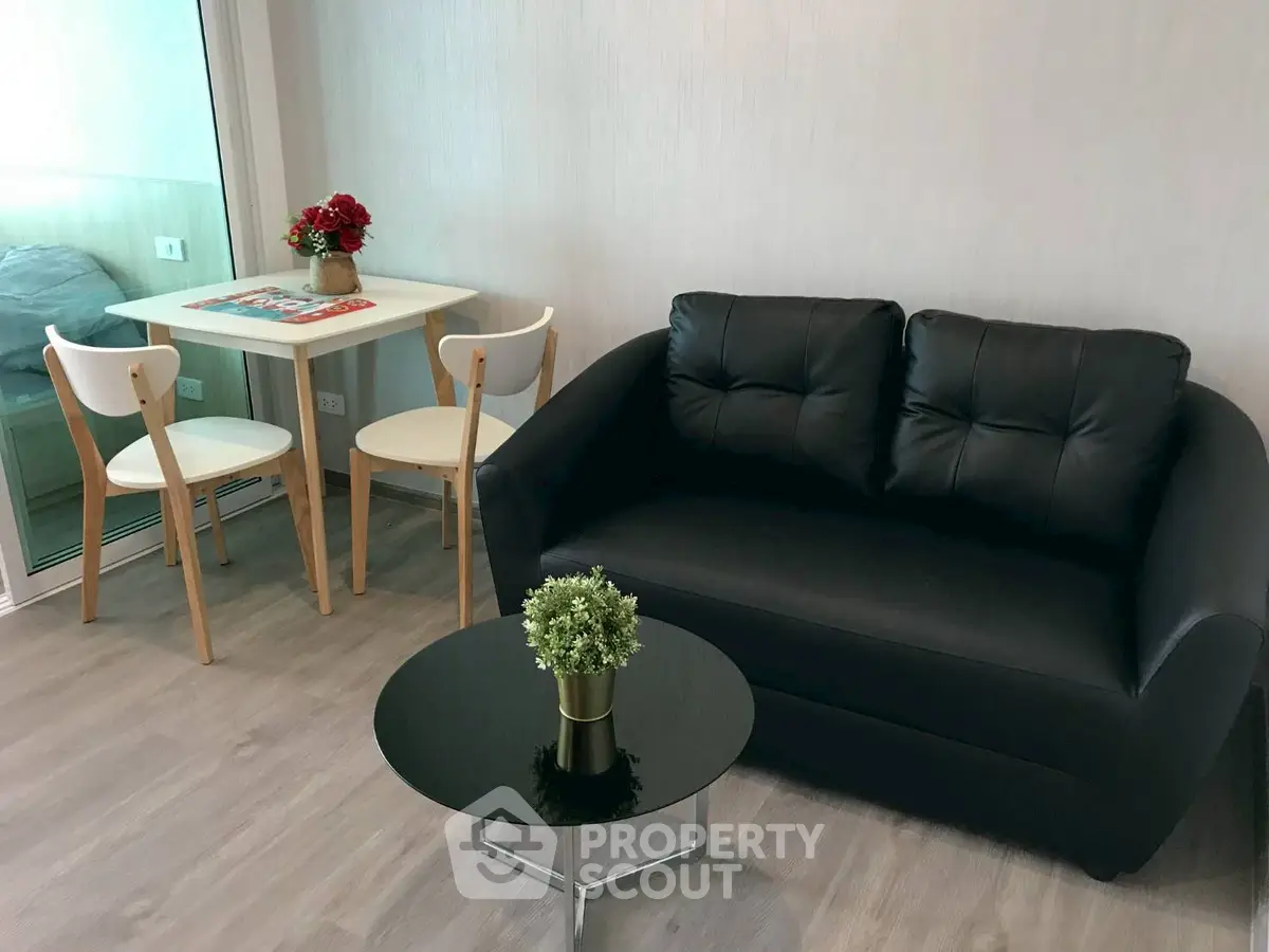 Modern living room with black sofa and stylish dining set