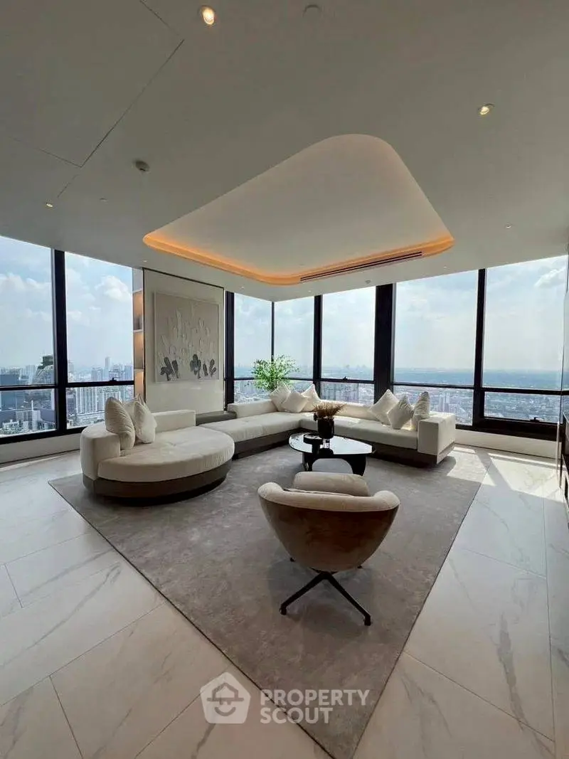 Luxurious living room with panoramic city views and modern furniture.