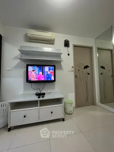 Modern living room with wall-mounted TV and air conditioning unit