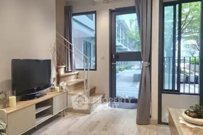 Modern living room with large windows and stylish decor in a contemporary apartment.