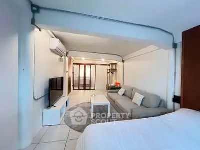 Spacious studio apartment with modern decor and cozy living area