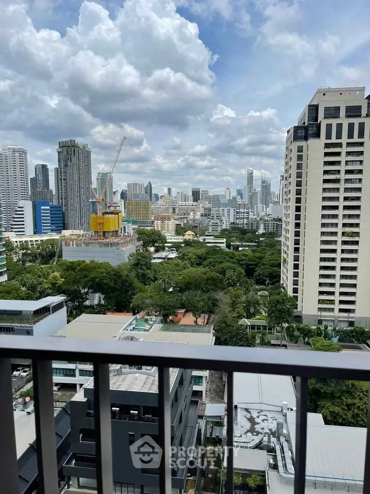 Stunning cityscape view from a high-rise balcony overlooking lush greenery and modern skyscrapers.