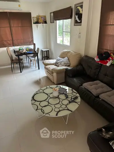 Cozy living room with modern furniture and natural light, perfect for relaxation and entertaining.