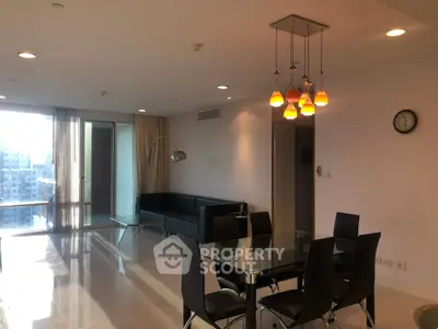 Modern living room with sleek furniture and city view, featuring elegant lighting and open space.