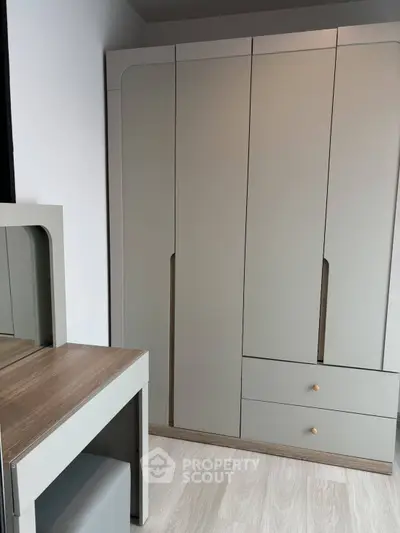 Modern bedroom with sleek wardrobe and stylish vanity set