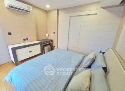Modern bedroom with stylish decor and air conditioning in a cozy apartment.