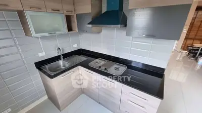Modern kitchen with sleek cabinetry and dual-burner stove