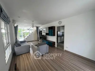 Spacious living room with modern decor and natural light