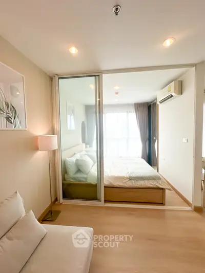 Modern bedroom with glass partition and cozy lighting in stylish apartment