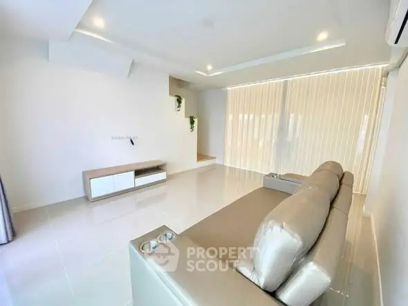 Spacious modern living room with sleek furniture and natural light