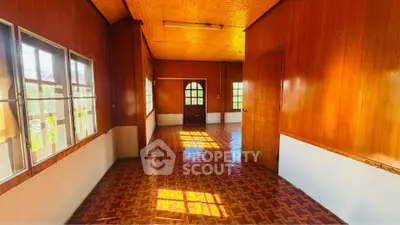 Charming wooden interior with warm lighting and parquet flooring, perfect for cozy living.