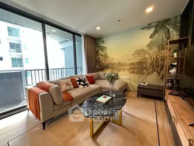 Stylish living room with large balcony and nature-themed mural