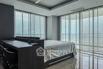 Luxurious bedroom with ocean view and modern decor in high-rise apartment