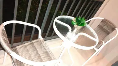Charming balcony with cozy seating and a small table, perfect for relaxing evenings.