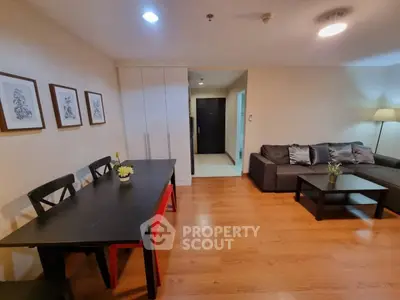 Spacious living room with modern furniture and wooden flooring in a stylish apartment.