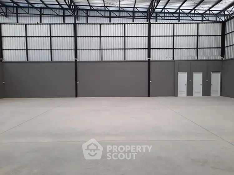 Spacious industrial warehouse with high ceilings and ample storage space.
